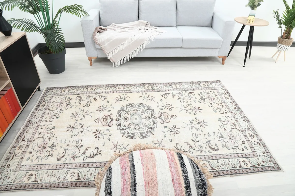 Overhead view of the small area rug placed in front of a sofa, showing its full length.
