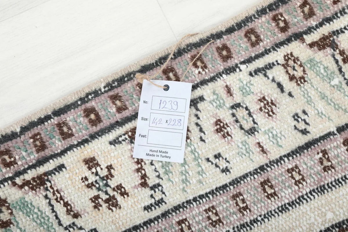Tag showing the rug's item number and 'Hand Made in Turkey' on the reverse side.