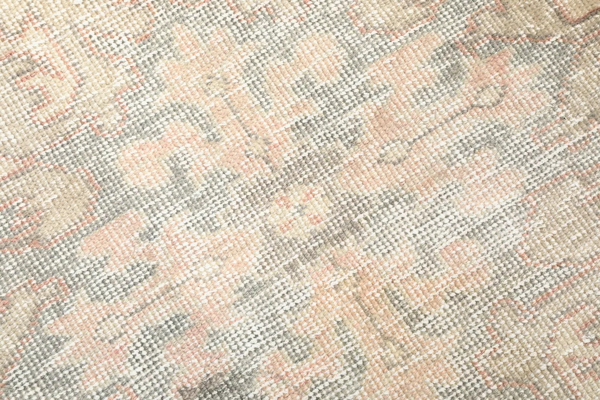 Texture shot of the low wool pile, illustrating the hand-knotted construction and color variations