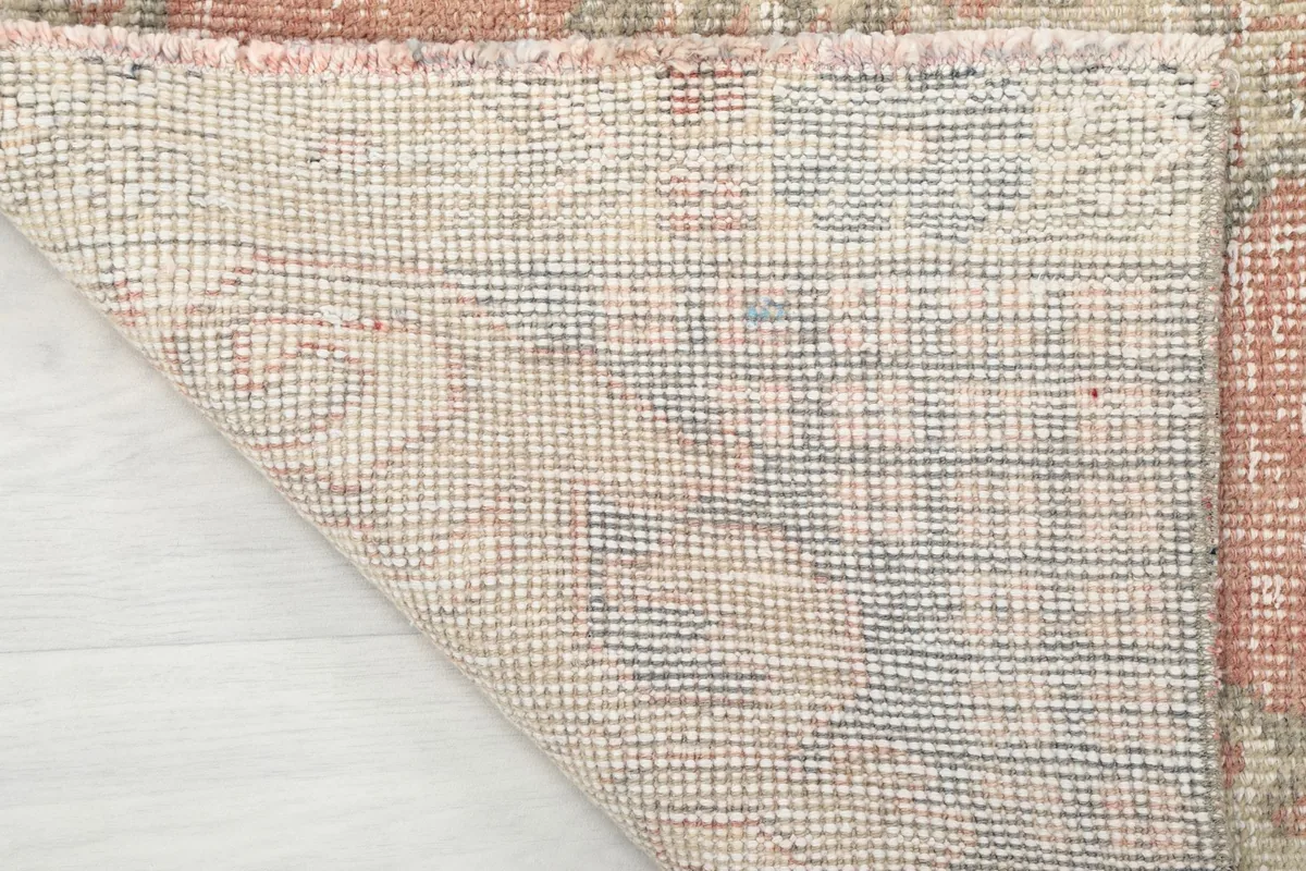 Underside of the hand-knotted rug, revealing the tight weave of the cotton foundation