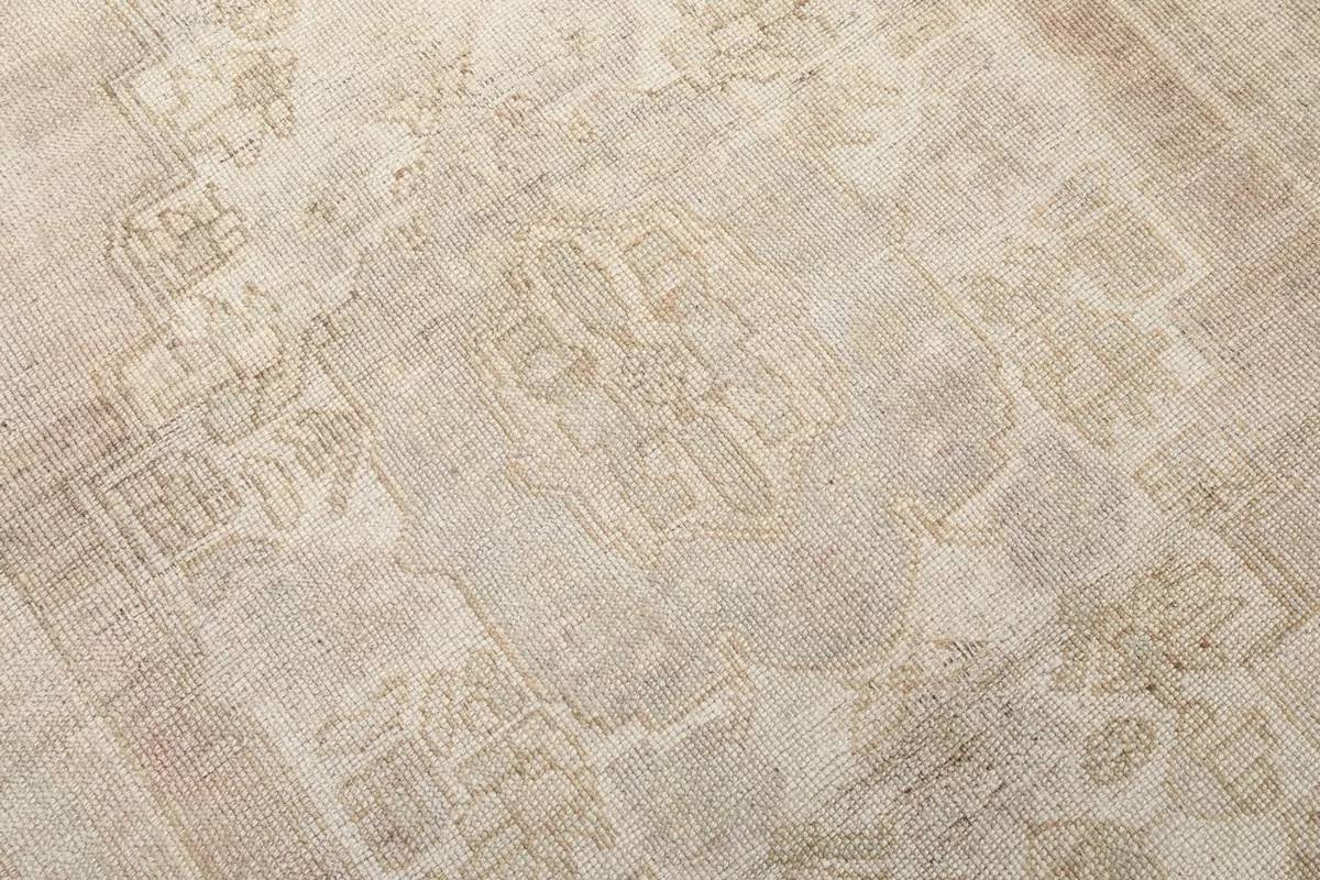 Close-up detail of the hand-knotted wool pile and the intricate geometric patterns within the medallion.