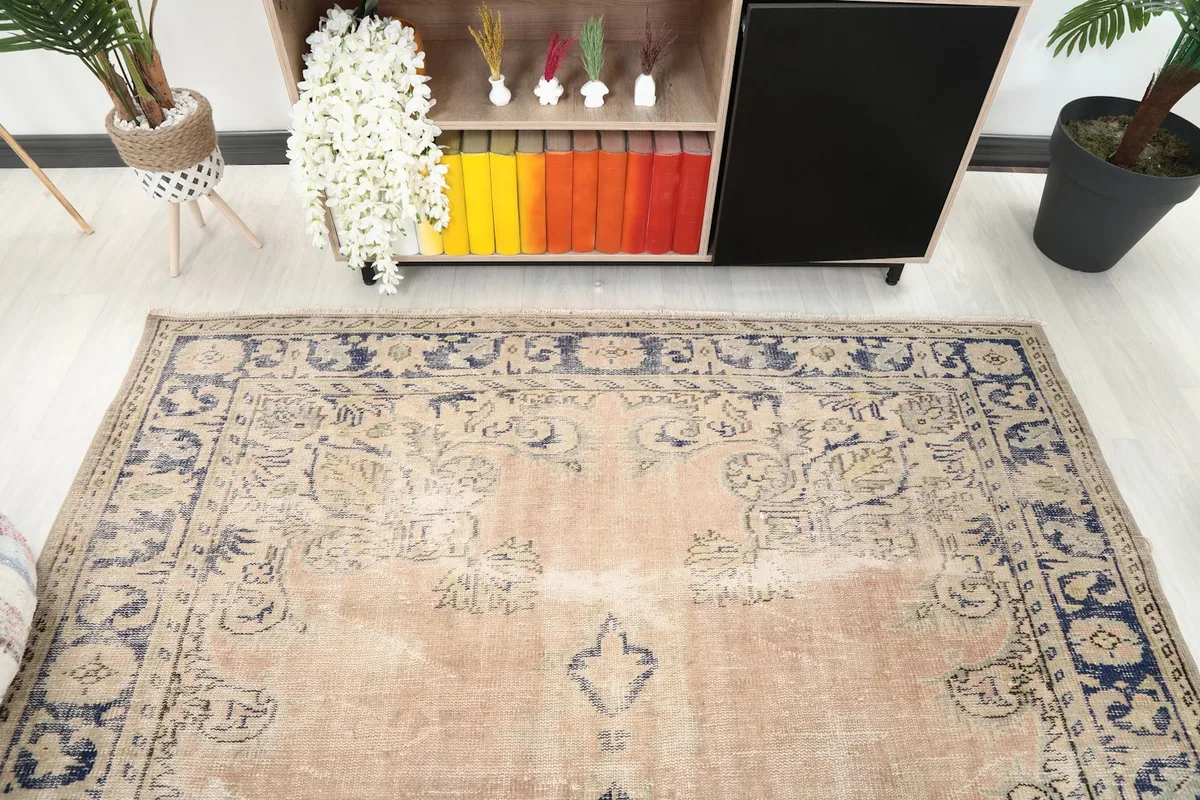 View of the vintage rug from above, showcasing its texture and colors next to furniture