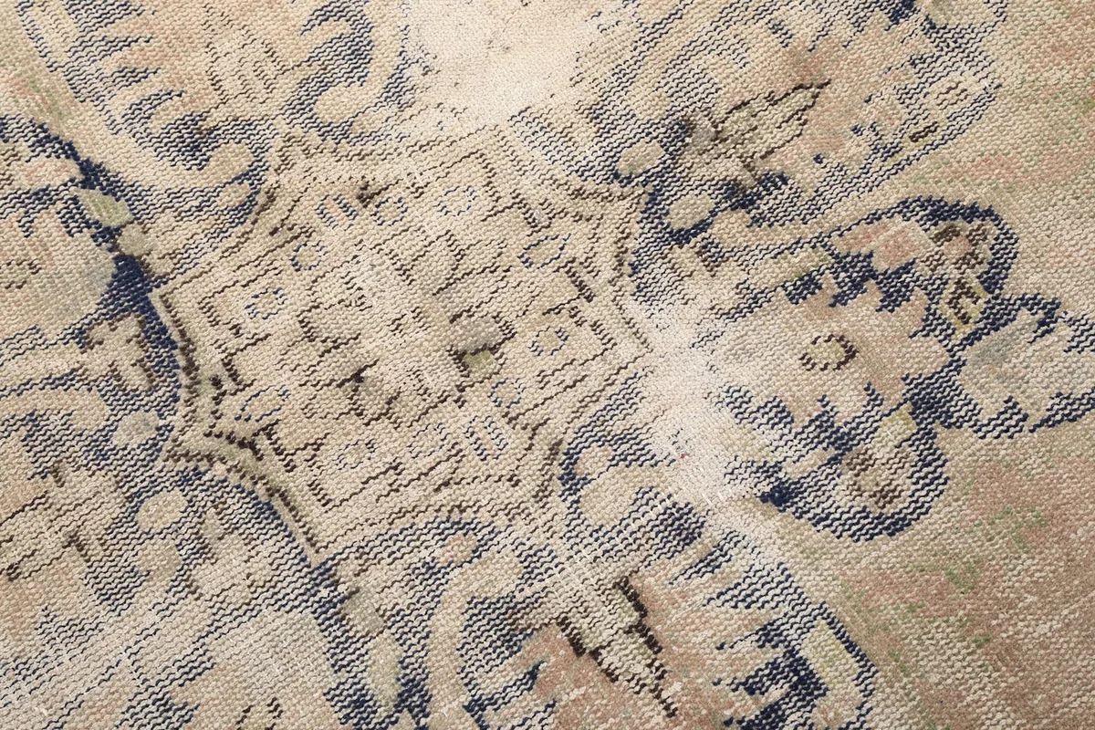 Close-up of the hand-knotted wool pile, showing the intricate details and color variations in the pattern