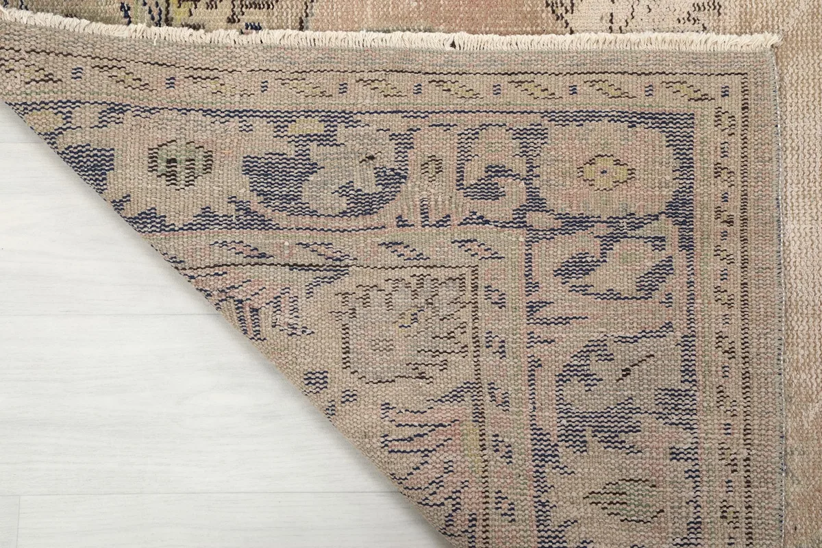 Close-up of the back of the rug, showing the dense hand-knotting and the cotton foundation