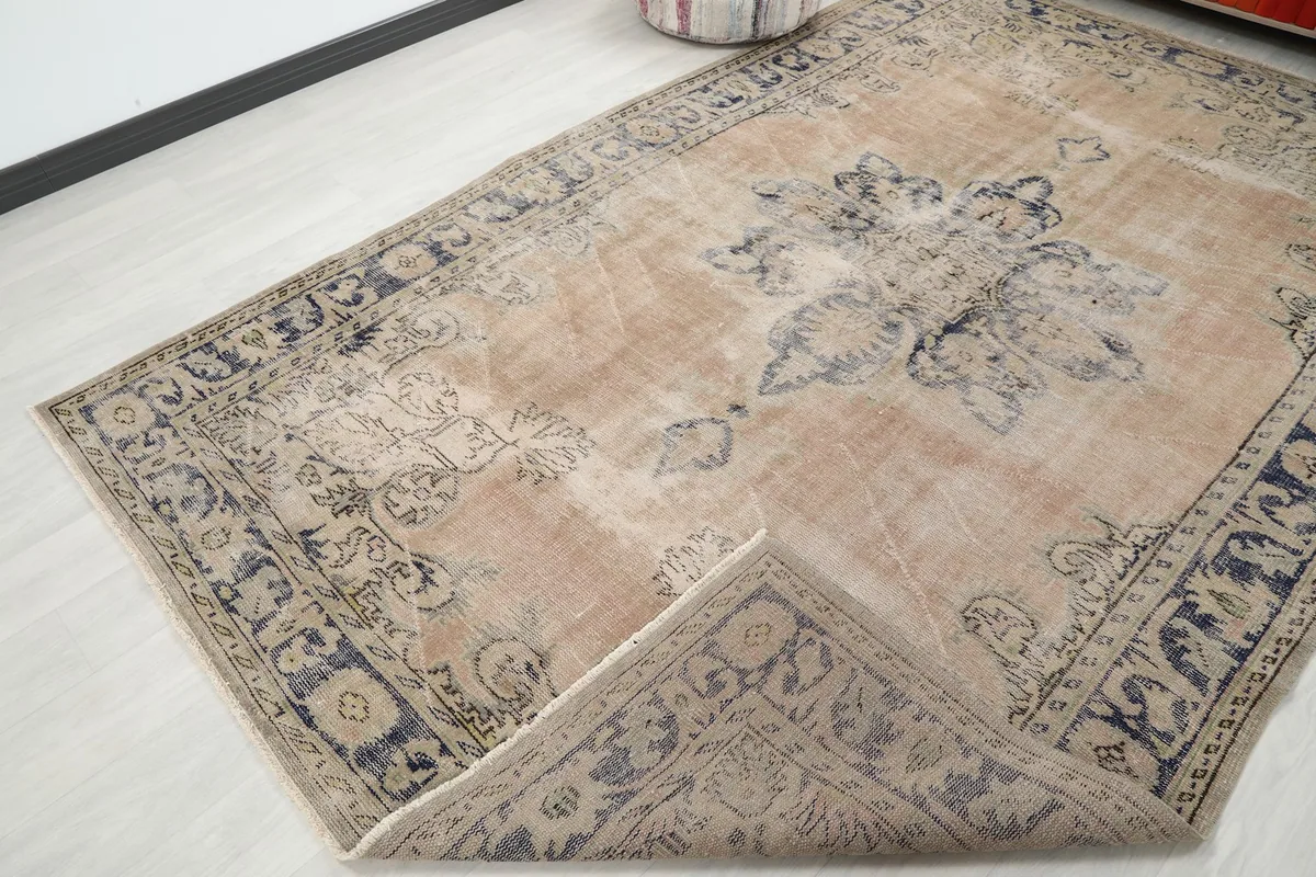 Rug corner folded back to reveal the back of the hand-knotted wool on cotton foundation