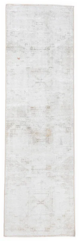 Full overhead view of the 2'7" x 9'2" cream vintage runner rug on a white background.