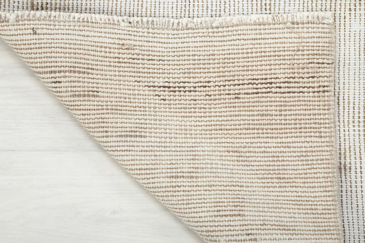 Another folded corner view, highlighting the texture and construction of the rug's reverse side.