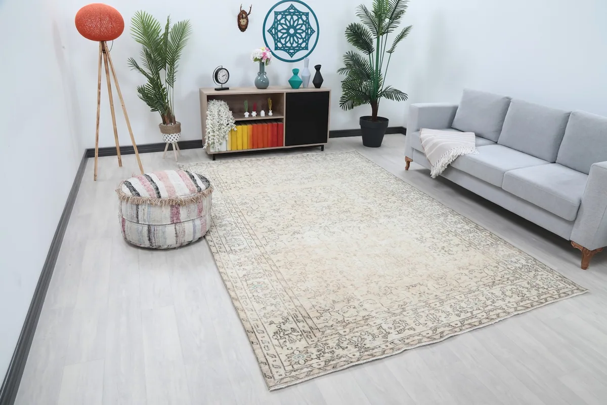 Angled view of the cream and gray vintage rug in a modern living space, showing its full size and placement.