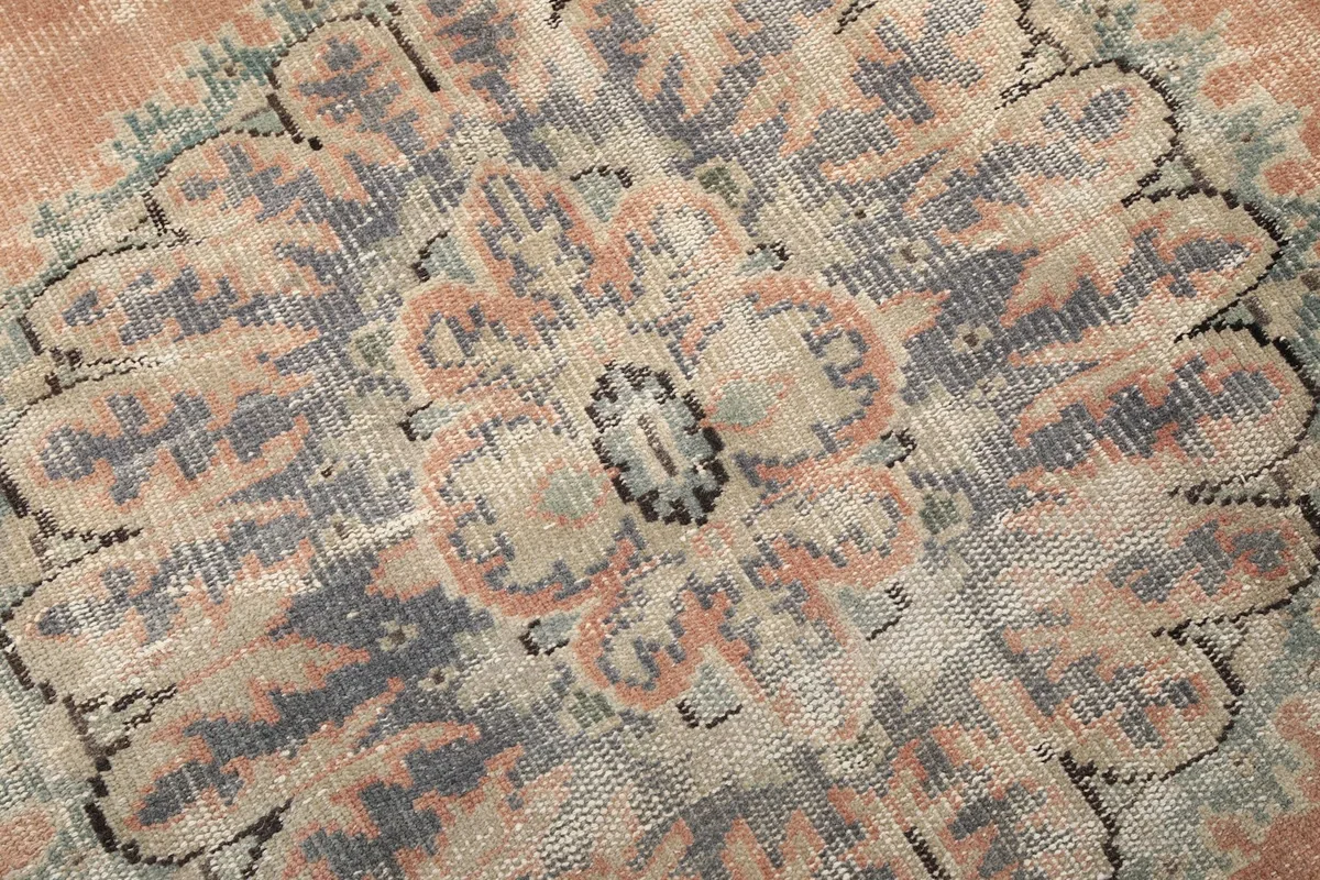 Texture of the low wool pile, showing the hand-knotted weave and vintage wear