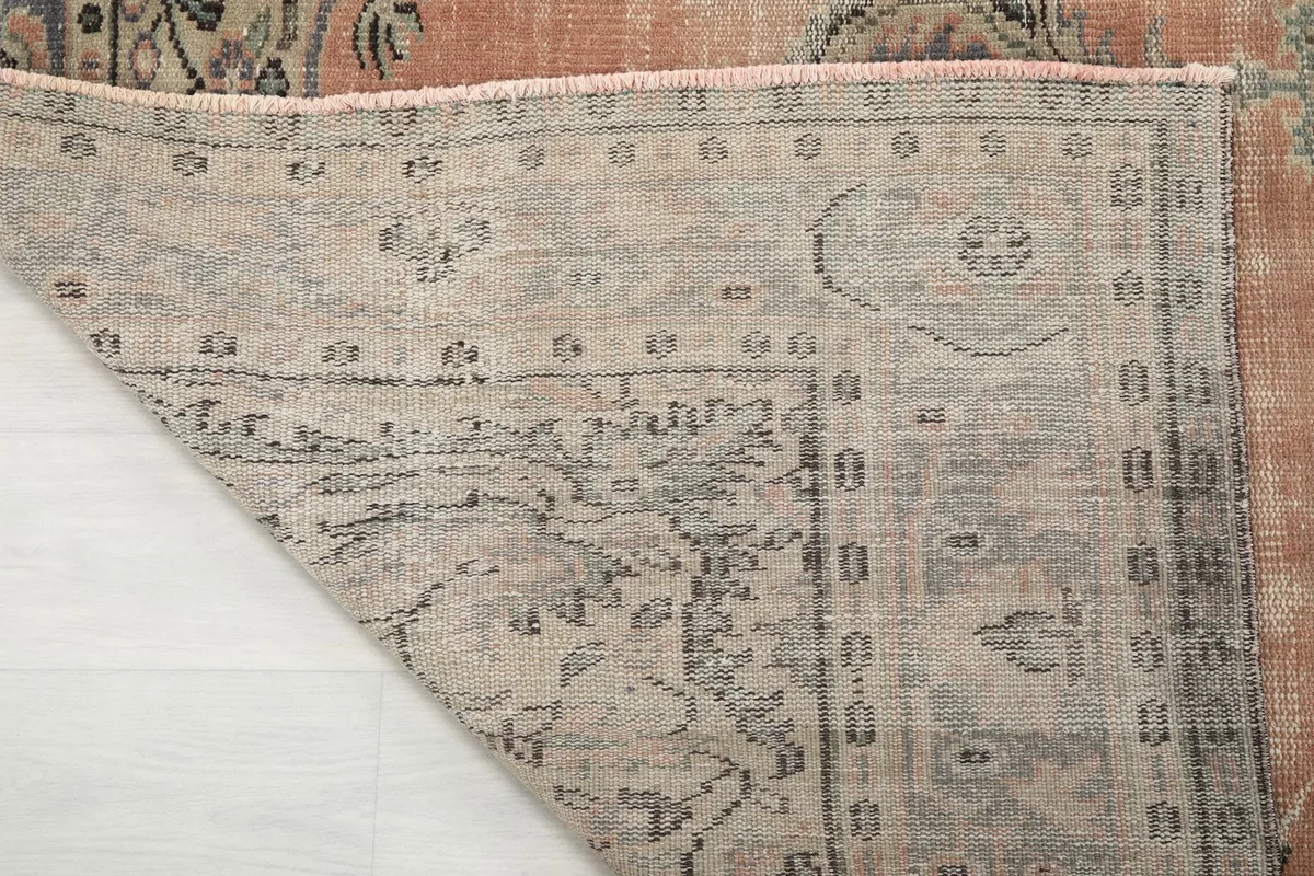 Close-up of the rug's underside, showing the reverse of the hand-knotted construction