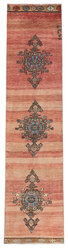 Full overhead view of the rust runner rug with geometric motifs on a white background.