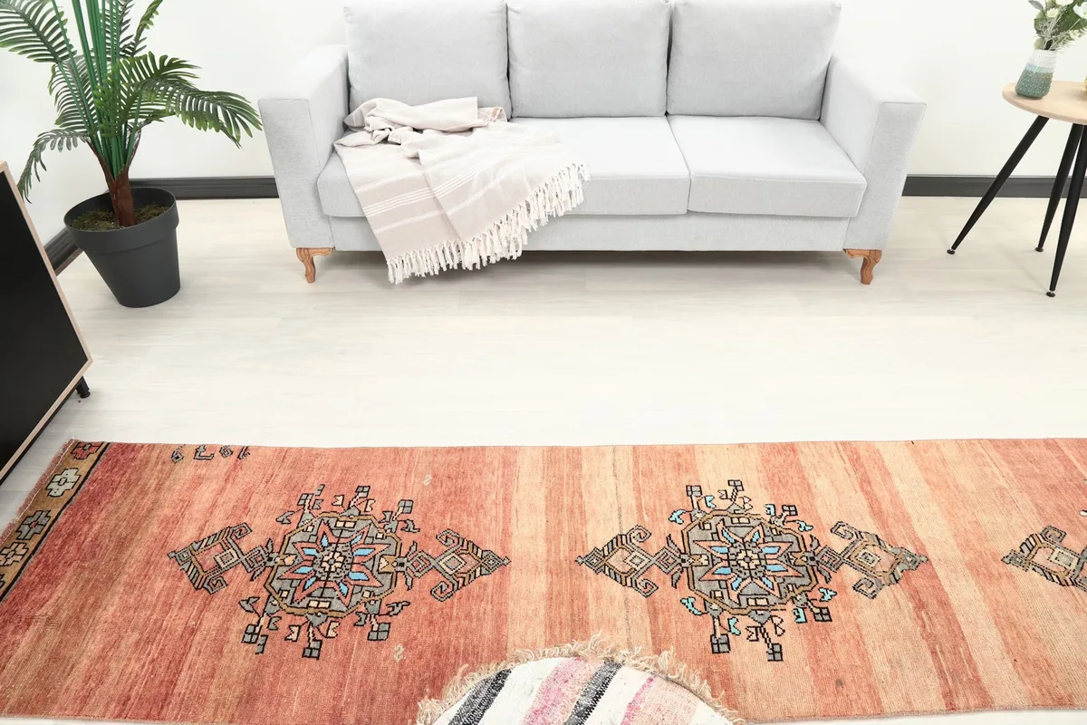Overhead view of the runner rug in a room, highlighting multiple geometric motifs and the sofa.