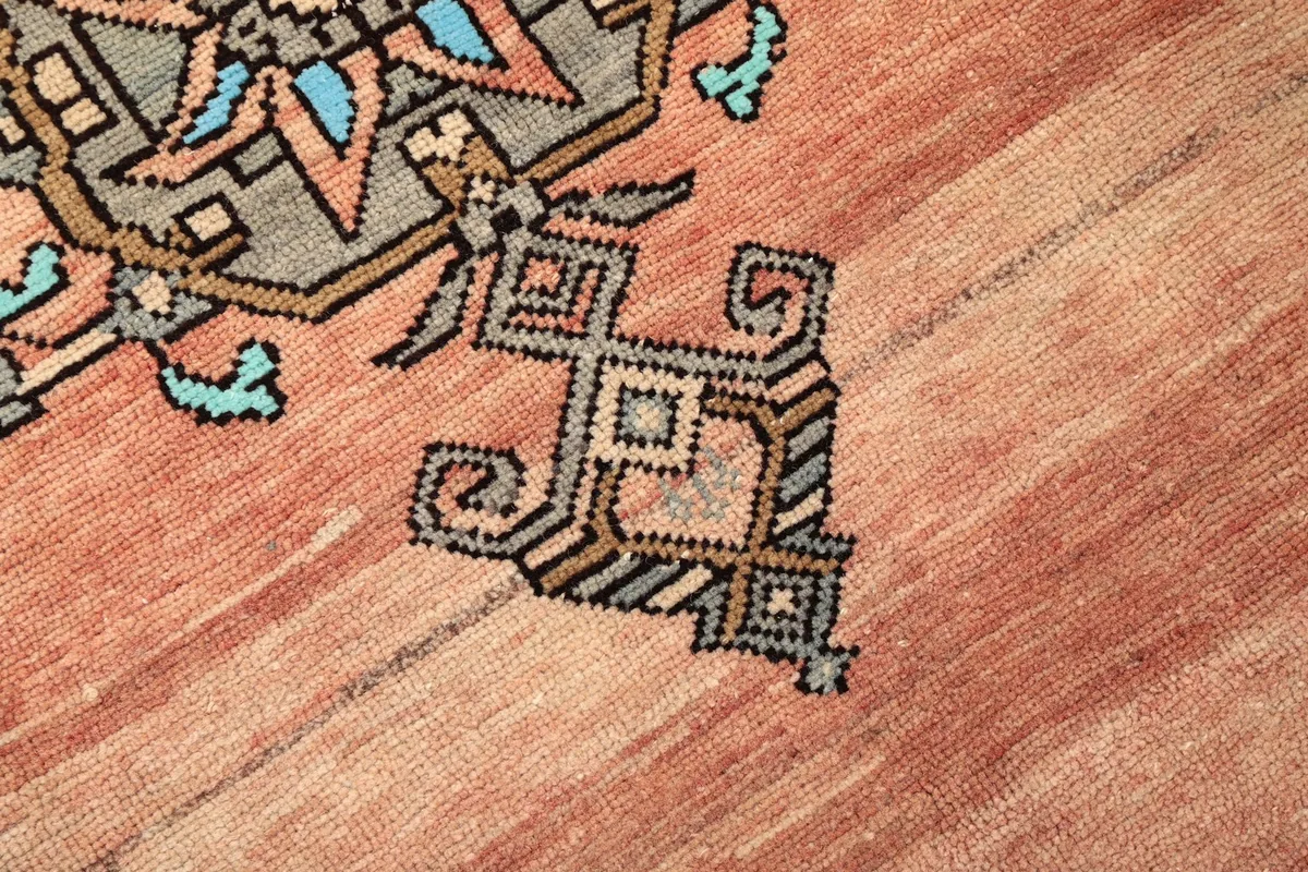Detailed view of the intricate geometric patterns and color variations within the rug's design.