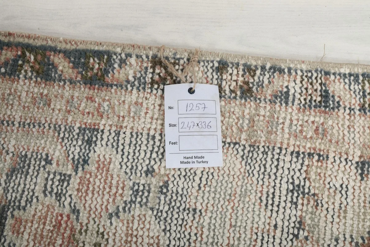 View of the rug's reverse side showing the cotton foundation and a product tag