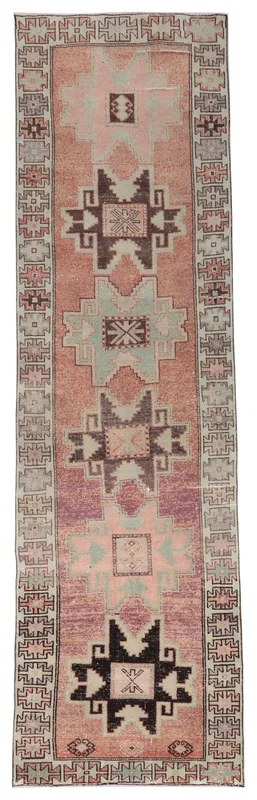 Full overhead view of the 3'8" x 12'9" rust and beige vintage Anatolian runner rug on a white background.