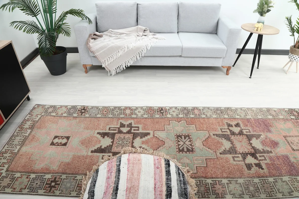 Long view of the rust and beige vintage runner rug extending through a modern living area.