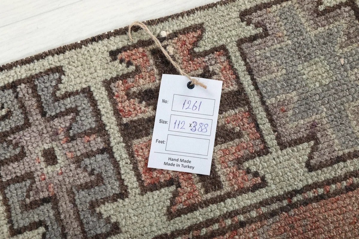 Tag showing the rug's dimensions (112 x 388 cm) and origin (Made in Turkey) on the rug's border.