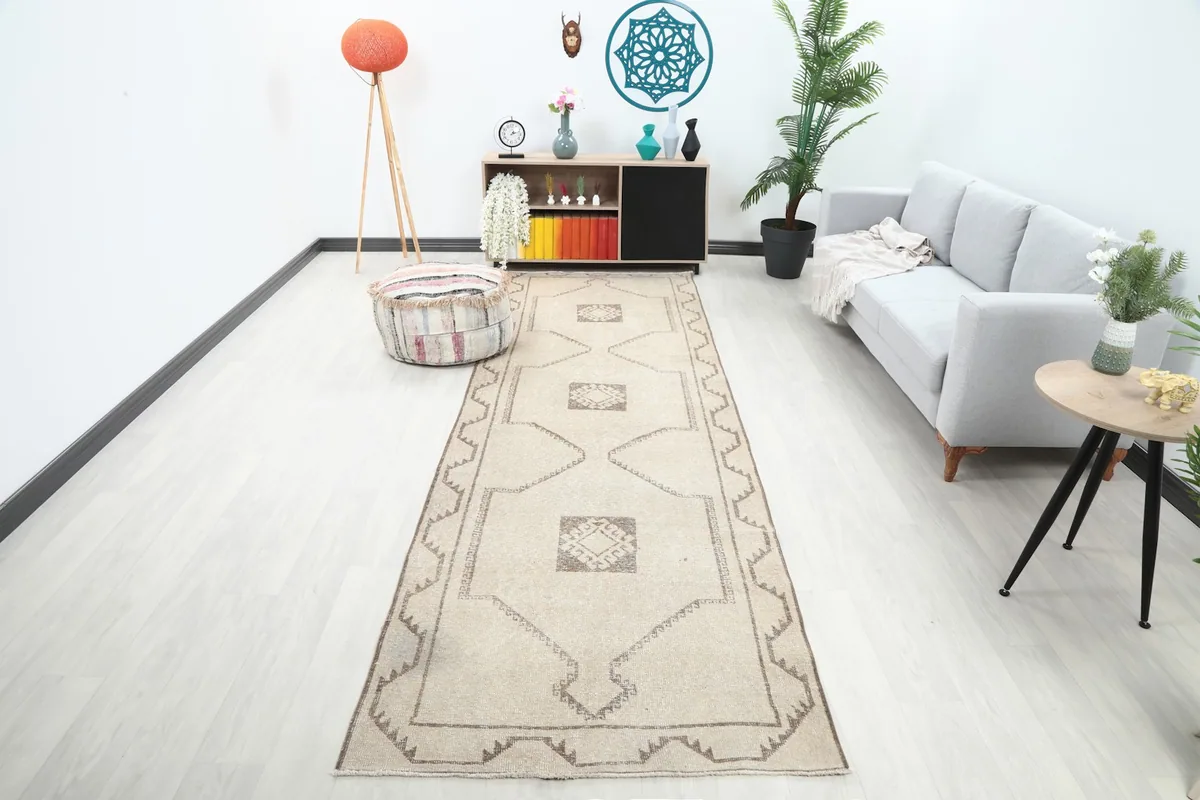 Ivory and brown runner rug in a modern hallway with a gray sofa