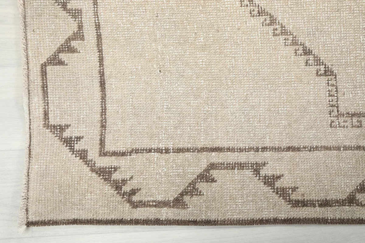 Corner detail showing the outer border with zigzag patterns and a subtle edge