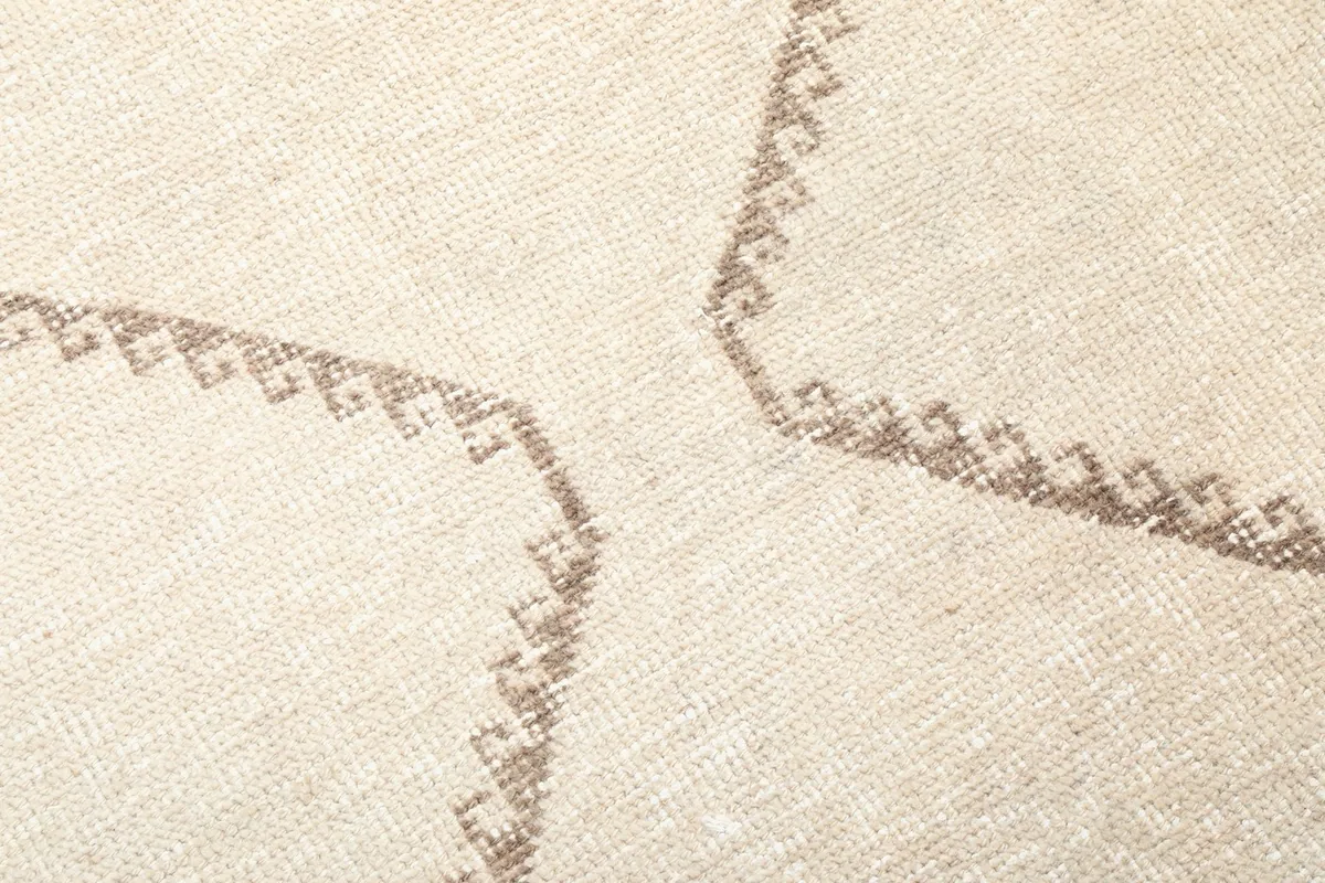 Close-up of the hand-knotted low pile and brown geometric lines