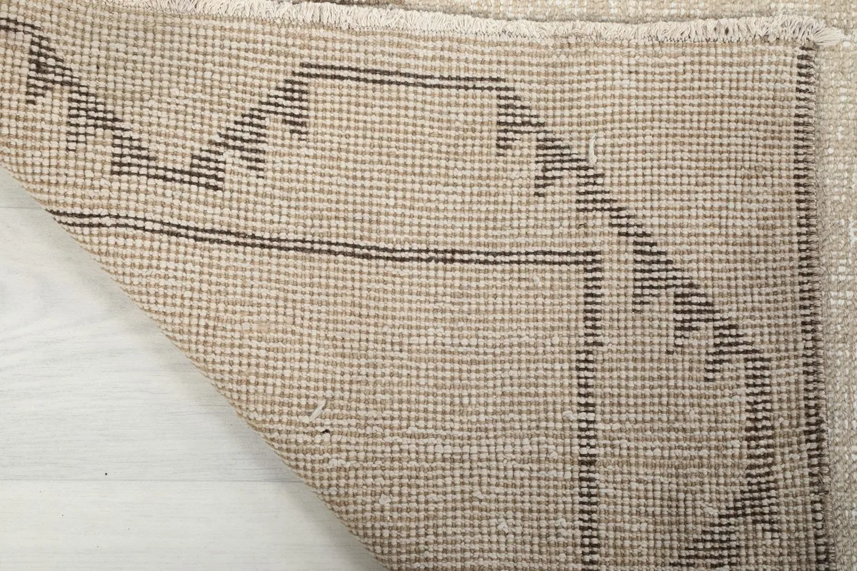 Underside view of the hand-knotted cotton foundation and reverse of the pattern