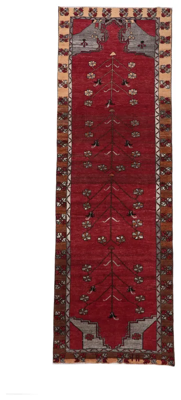 Full overhead view of the red floral Anatolian runner against a white background.