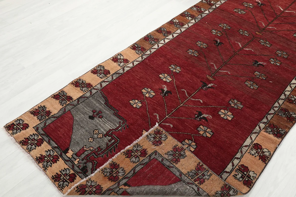 Angled view of the runner with a corner folded back, revealing the reverse side and knotting.