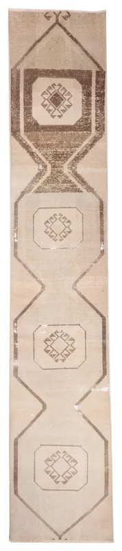 Full overhead view of a 2'8" x 14'9" tan and brown vintage Anatolian runner rug