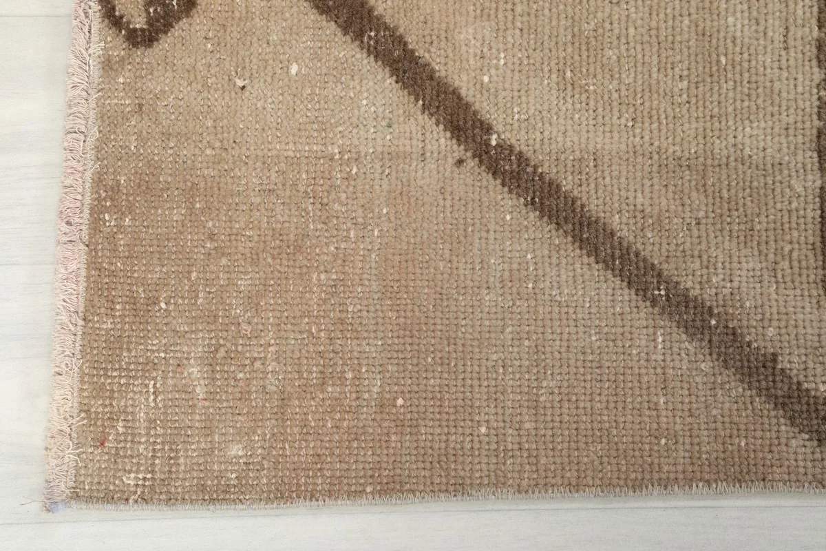 Texture of the low wool pile on the vintage runner rug, showing subtle variations in color
