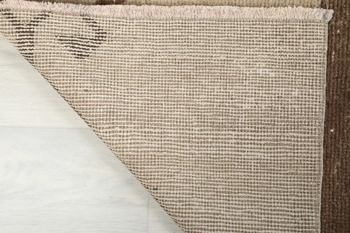 Underside of the vintage rug, revealing the tightly woven cotton foundation