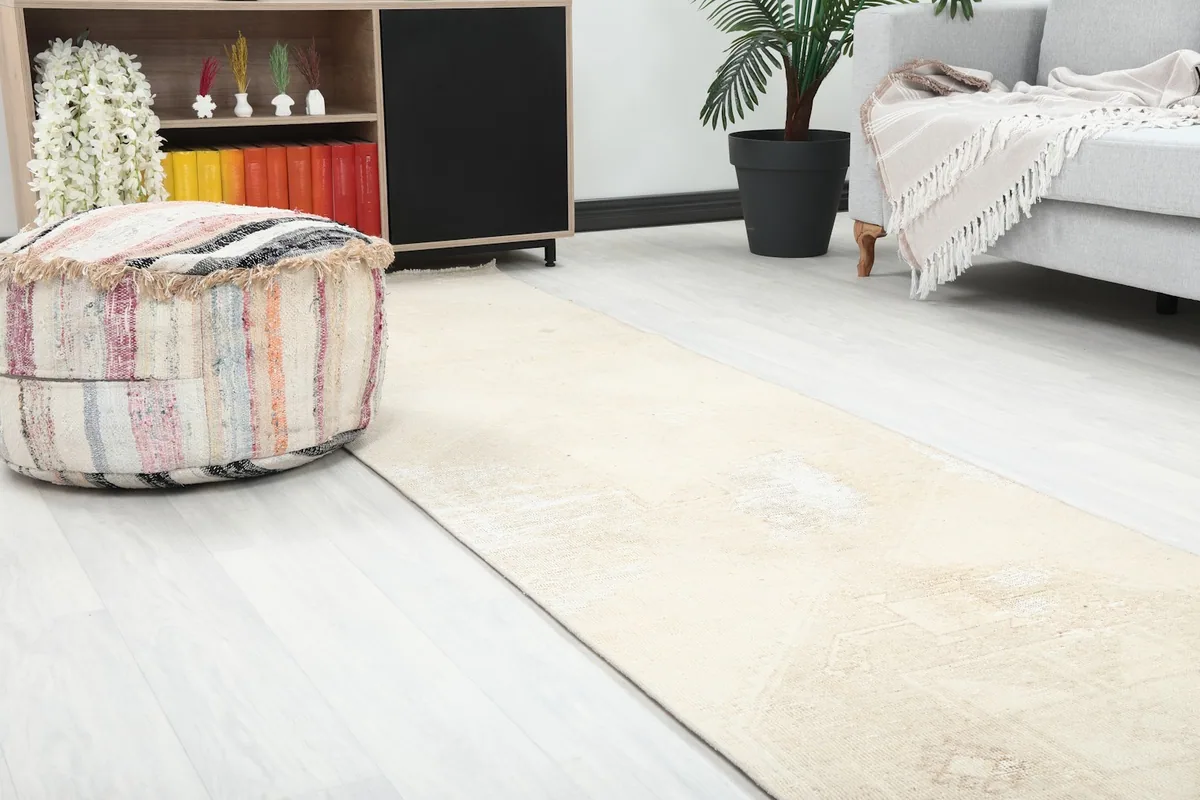Close-up view of the beige runner rug's texture and pattern details within a room setting.