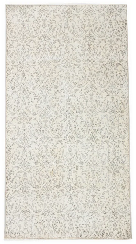 Full overhead view of the 3'7" x 6'9" ivory and gray floral vintage Anatolian area rug on a white background.