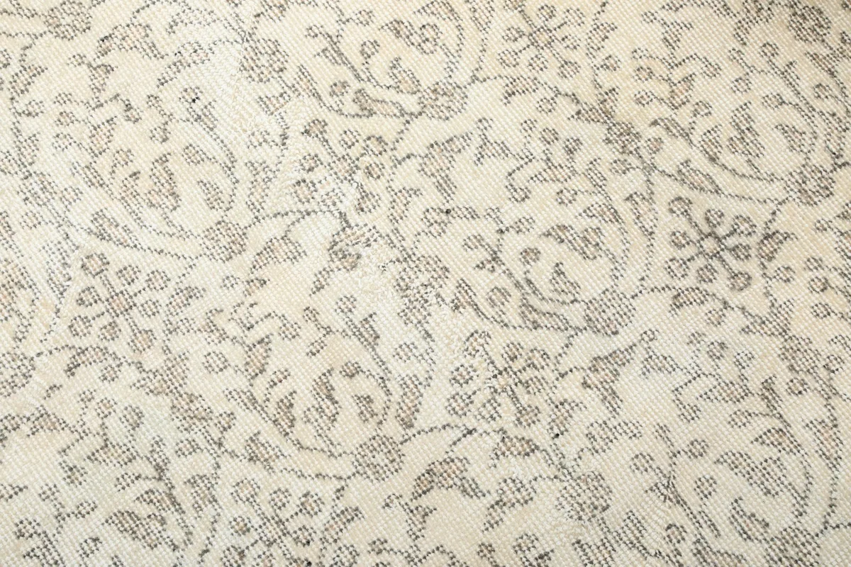 Detailed view of the rug's pattern, showing the variety of floral and geometric shapes in gray tones.