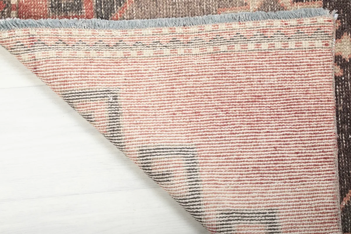 View of the back of the hand-knotted runner rug, showcasing the cotton foundation and fine craftsmanship