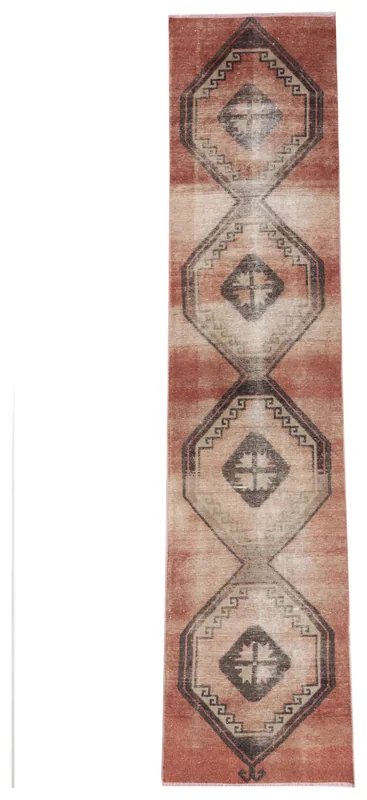 Full overhead view of the rust geometric Anatolian runner on a white background