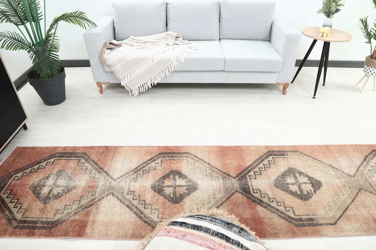 Overhead view showing the runner's length in a room with a sofa and side table