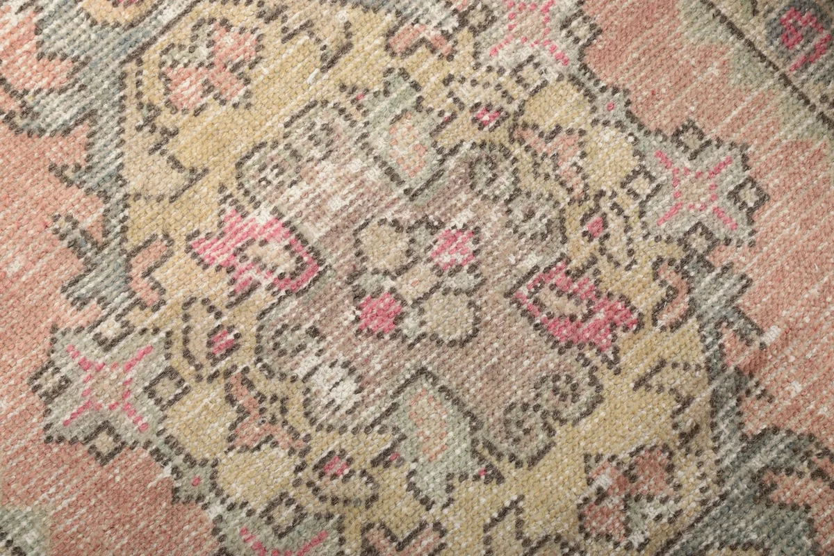 Very close detail of the hand-knotted wool pile and intricate tribal patterns