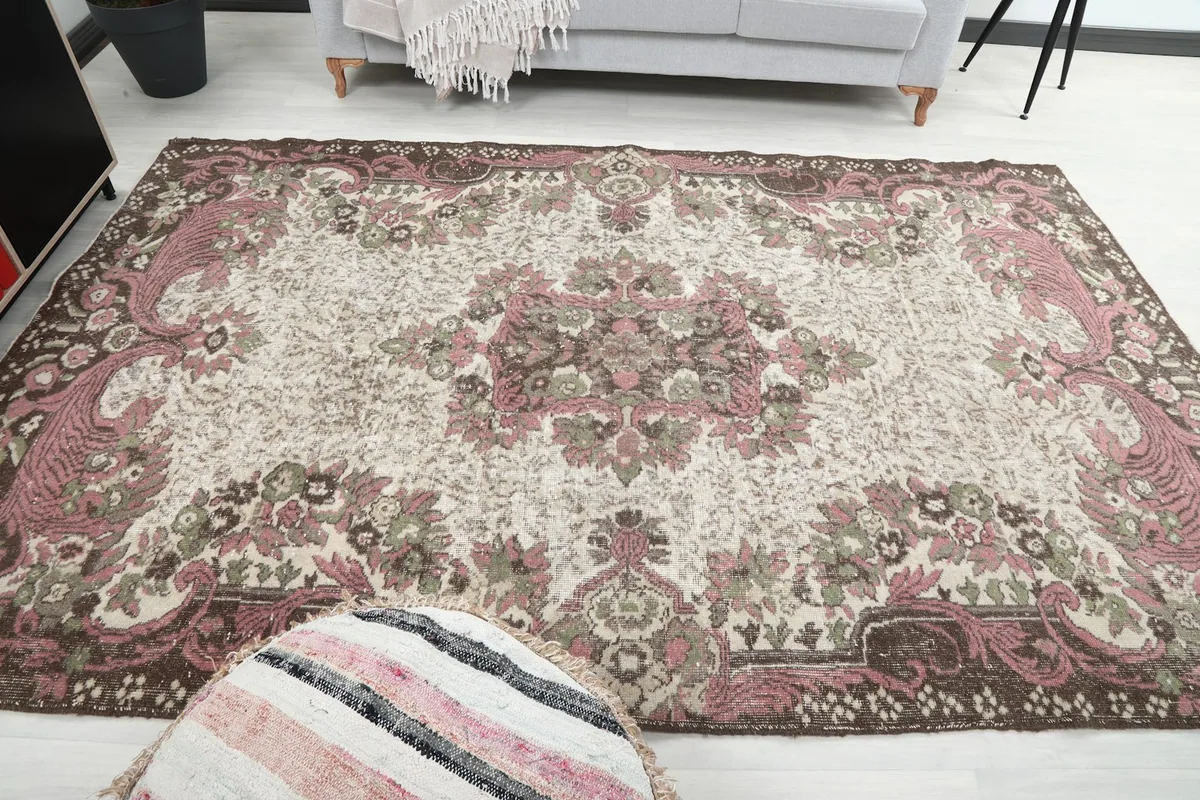 View of the rug from another angle in the room, showing the pink and brown tones.