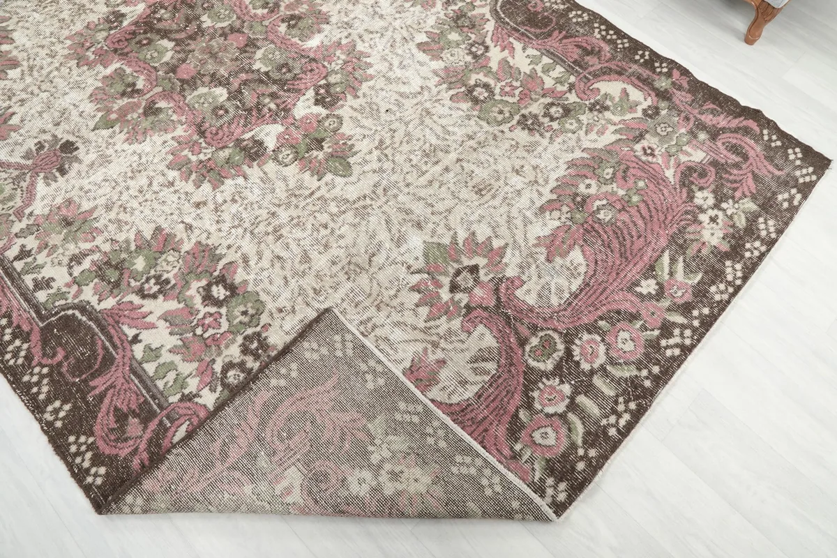 Folded corner of the rug, revealing the cotton foundation and density of the hand-knotted wool pile.