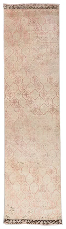 Full overhead view of the beige and rose geometric runner rug on a white background