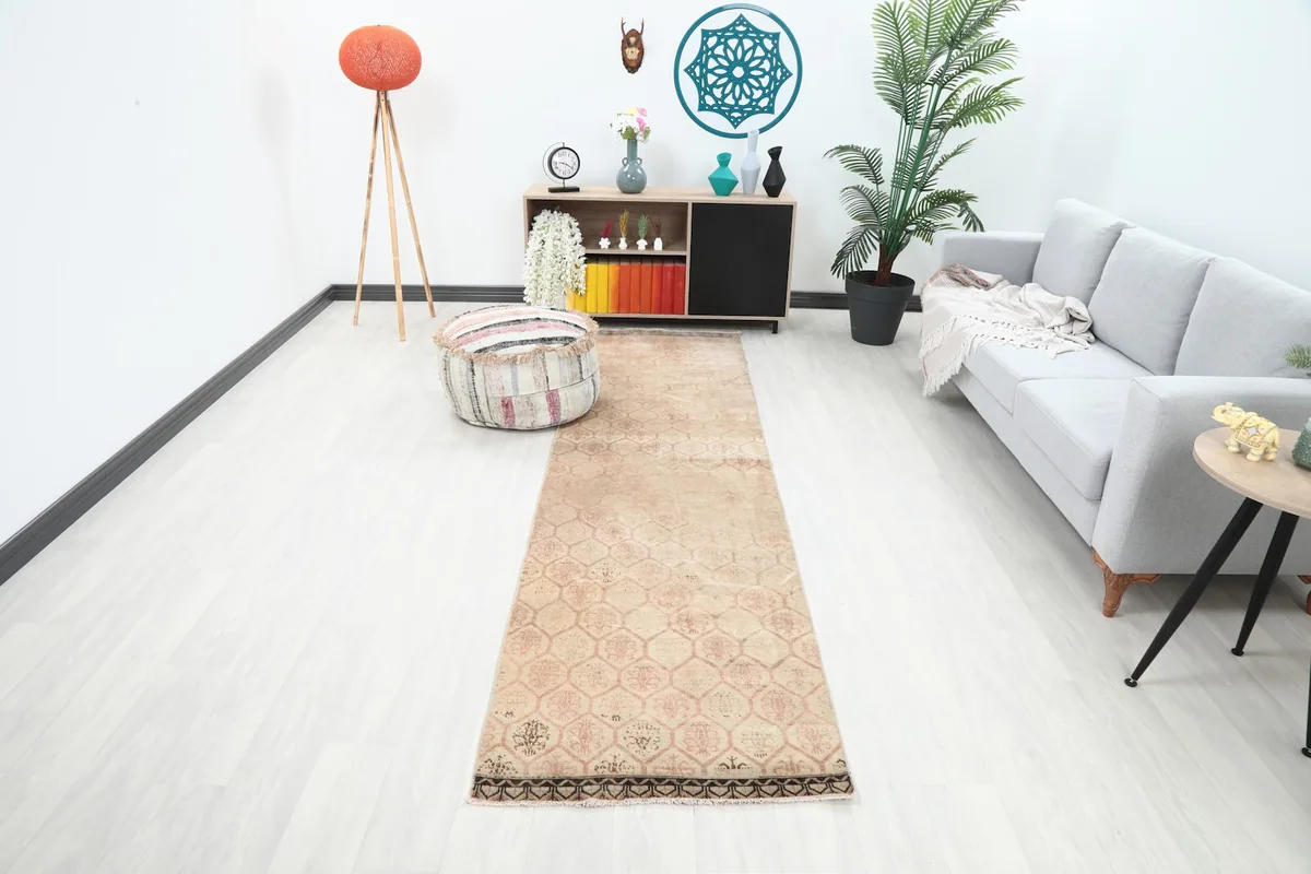 Runner rug laid out in a modern hallway with light-colored flooring and furniture
