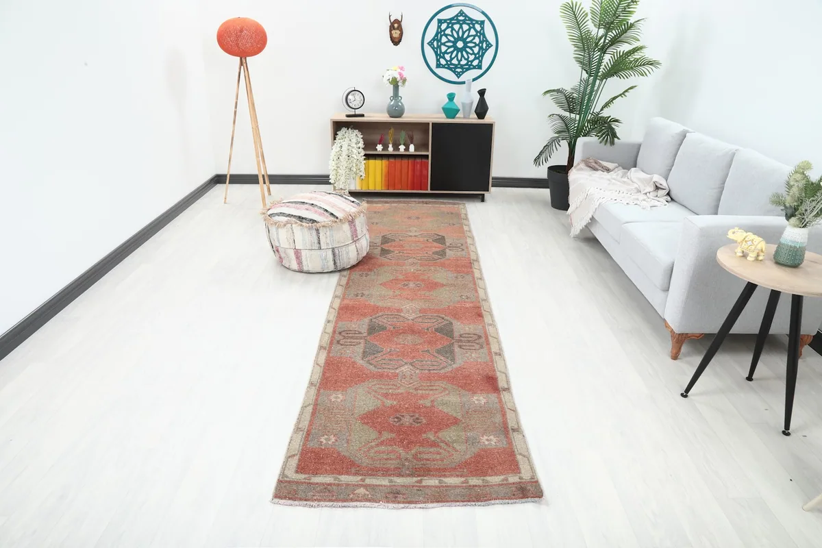Rust runner rug displayed in a modern living space with a gray sofa and wooden furniture.