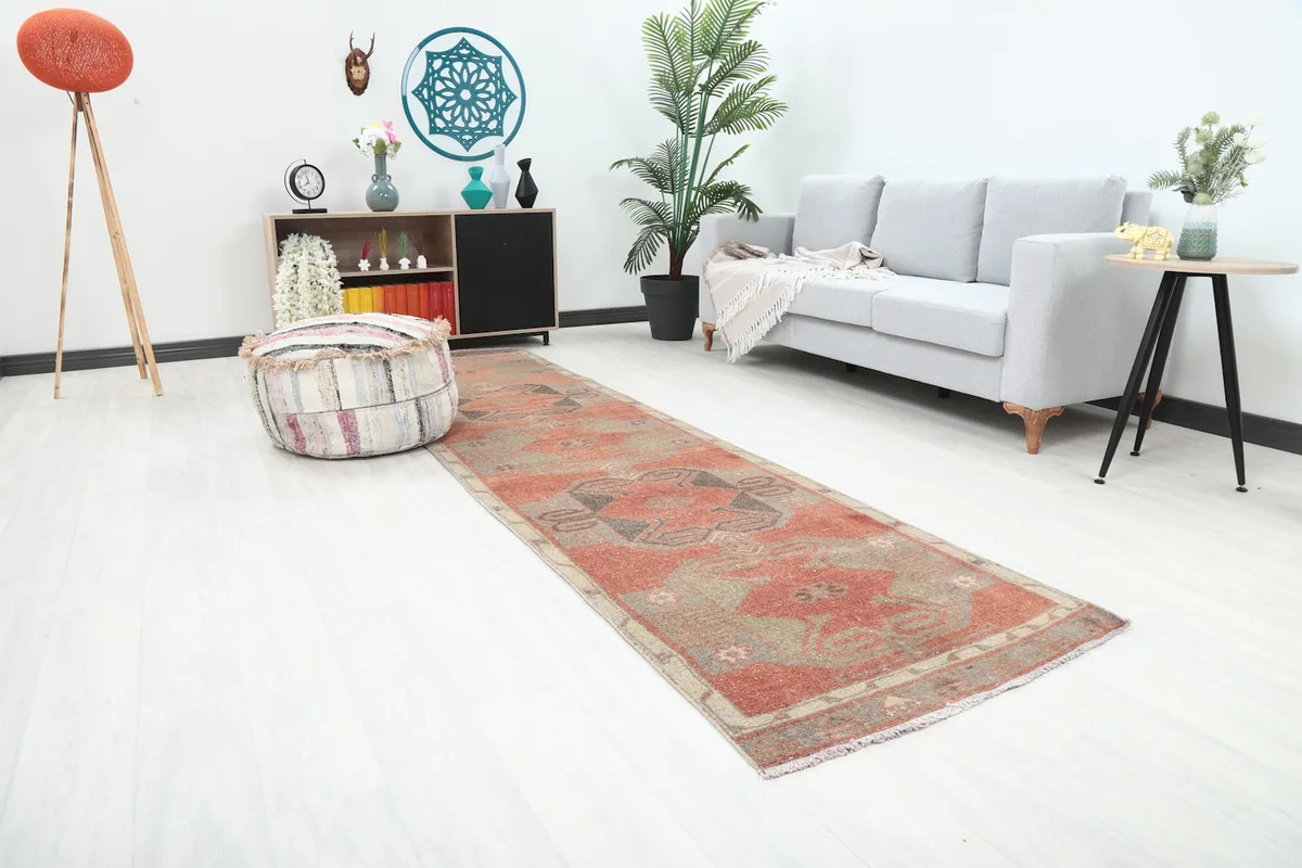 Angled view of the rust runner rug in a room, showing its length and placement.