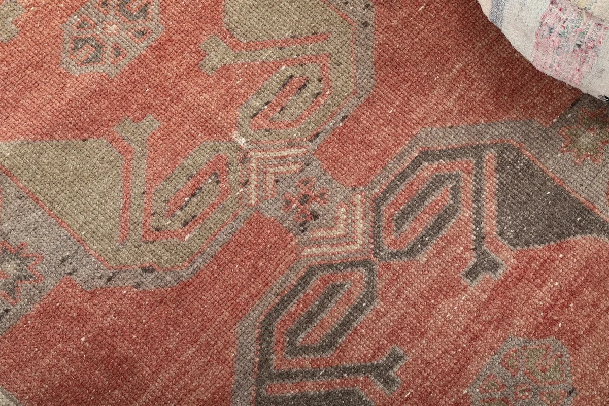 Close-up of a specific geometric motif within the rust runner rug's design.