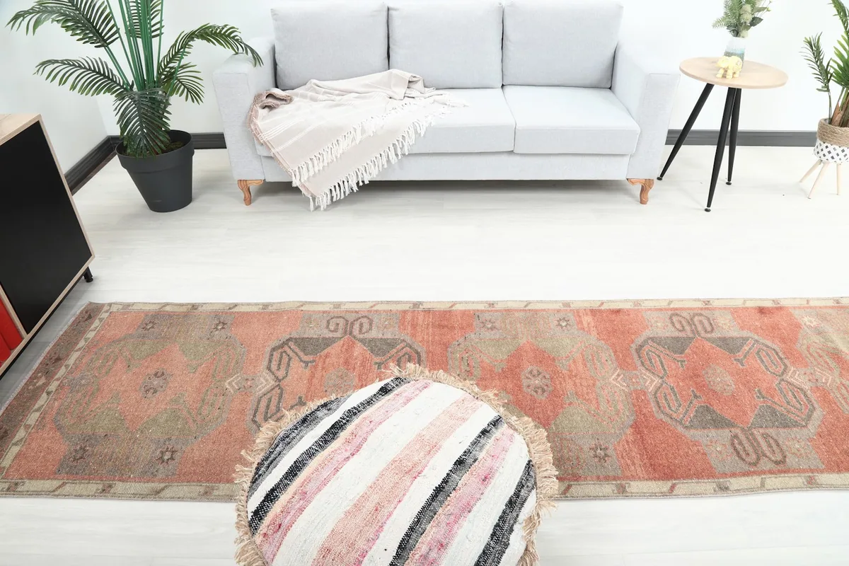 Overhead view of the middle section of the rust runner rug, showing the motifs.