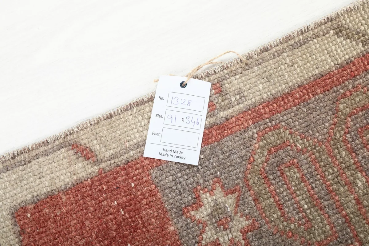 Tag with rug details attached to the corner of the hand-knotted vintage runner.