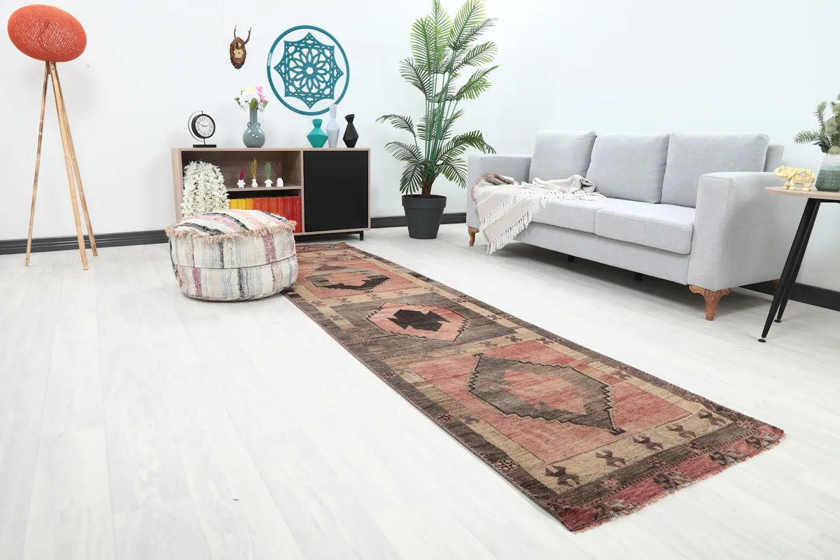 Angle view of the runner rug in a modern living space, highlighting its rose and gray tones