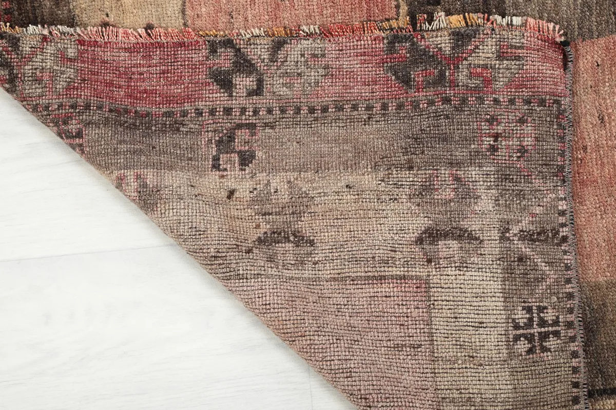 Underside view of the hand-knotted cotton foundation, showing the rug's construction