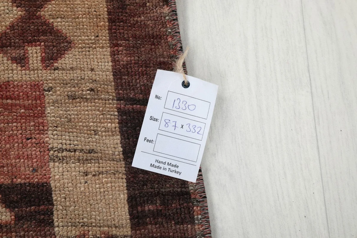 Close-up of the size tag attached to the vintage Anatolian runner rug, displaying dimensions