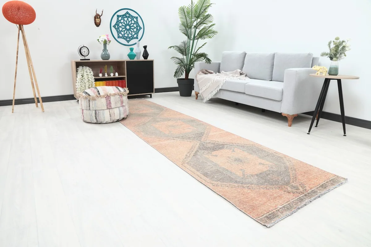 Angle view of the 3x12 runner rug extending through a contemporary room with light furniture.